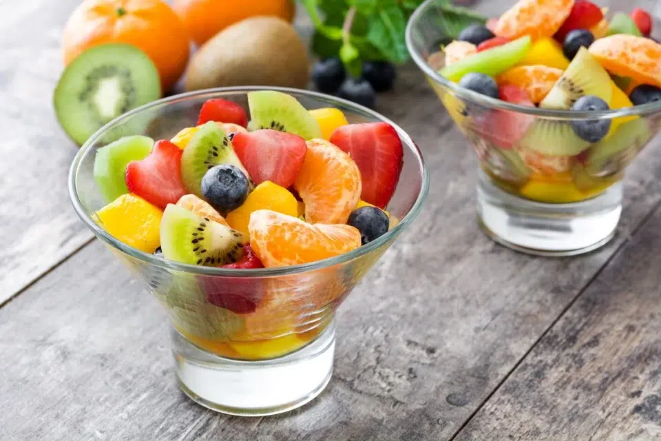 Colorful fruit cup with berries, melon, and grapes